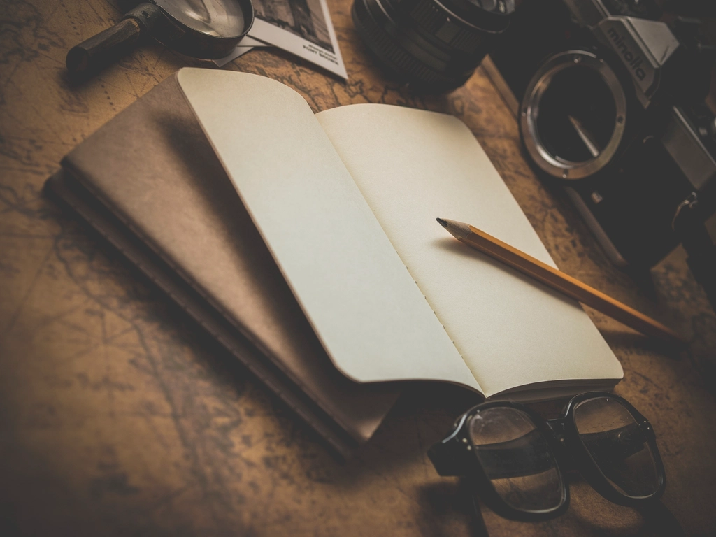 Open notebook and map for trip planning