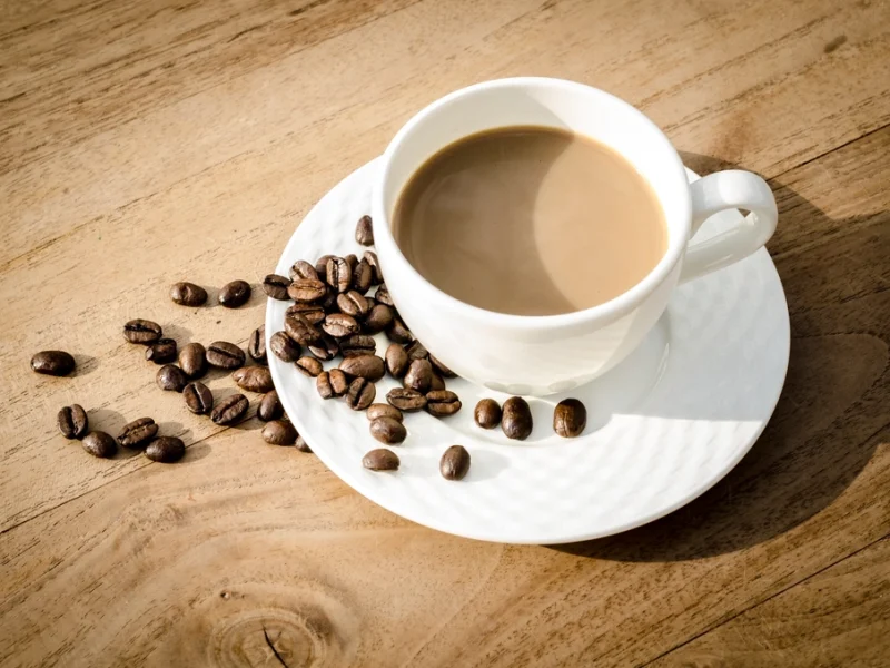 Cup of coffee with roasted beans